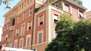 A multi-story building with balconies and windows. - Dea Roma Inn (Rome)
