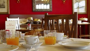A breakfast setting with croissants, coffee, and orange juice on a table. - Hotel Città Dei Mille (Bergamo)