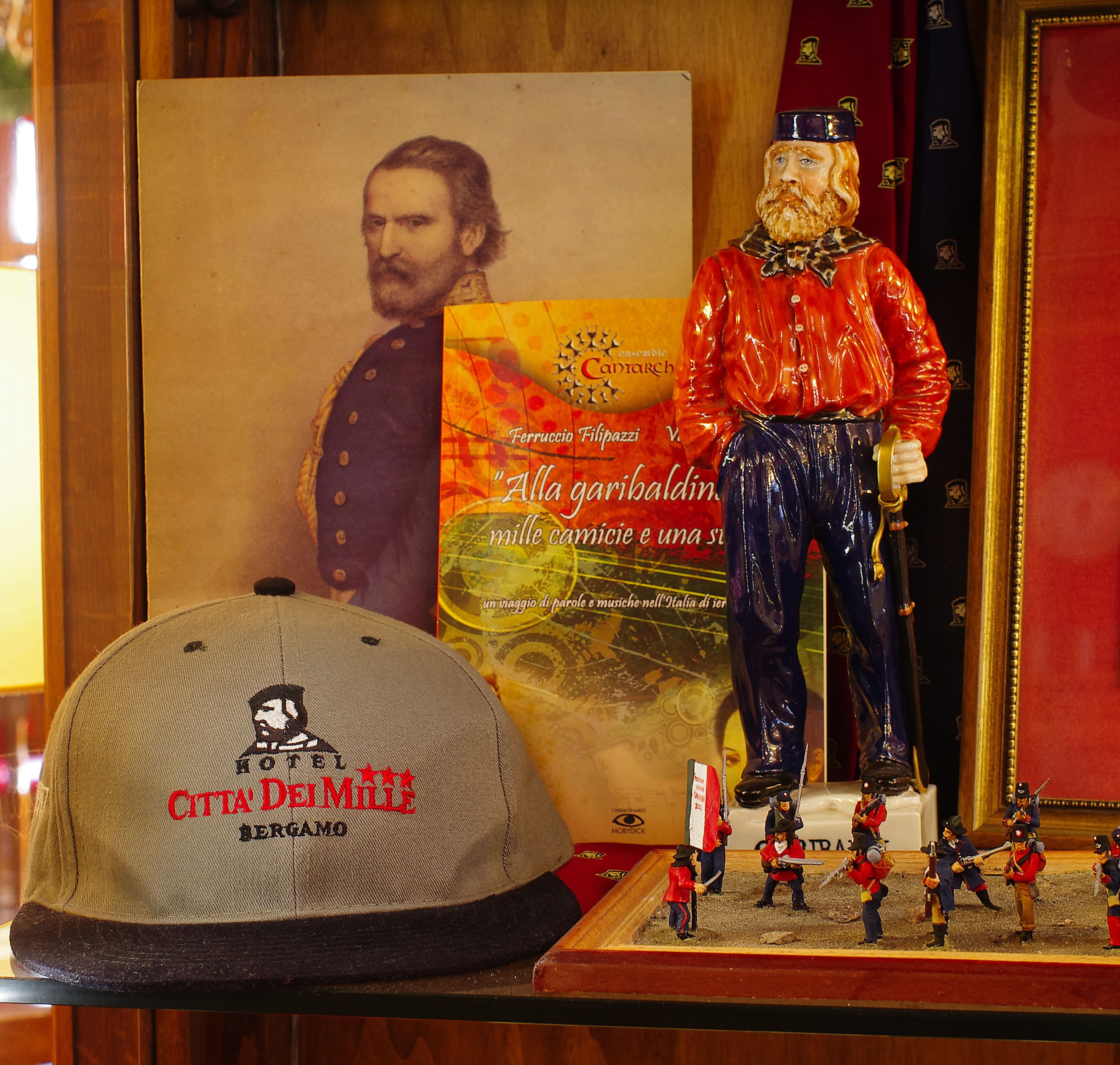 A figurine, a book, and a cap with a logo.