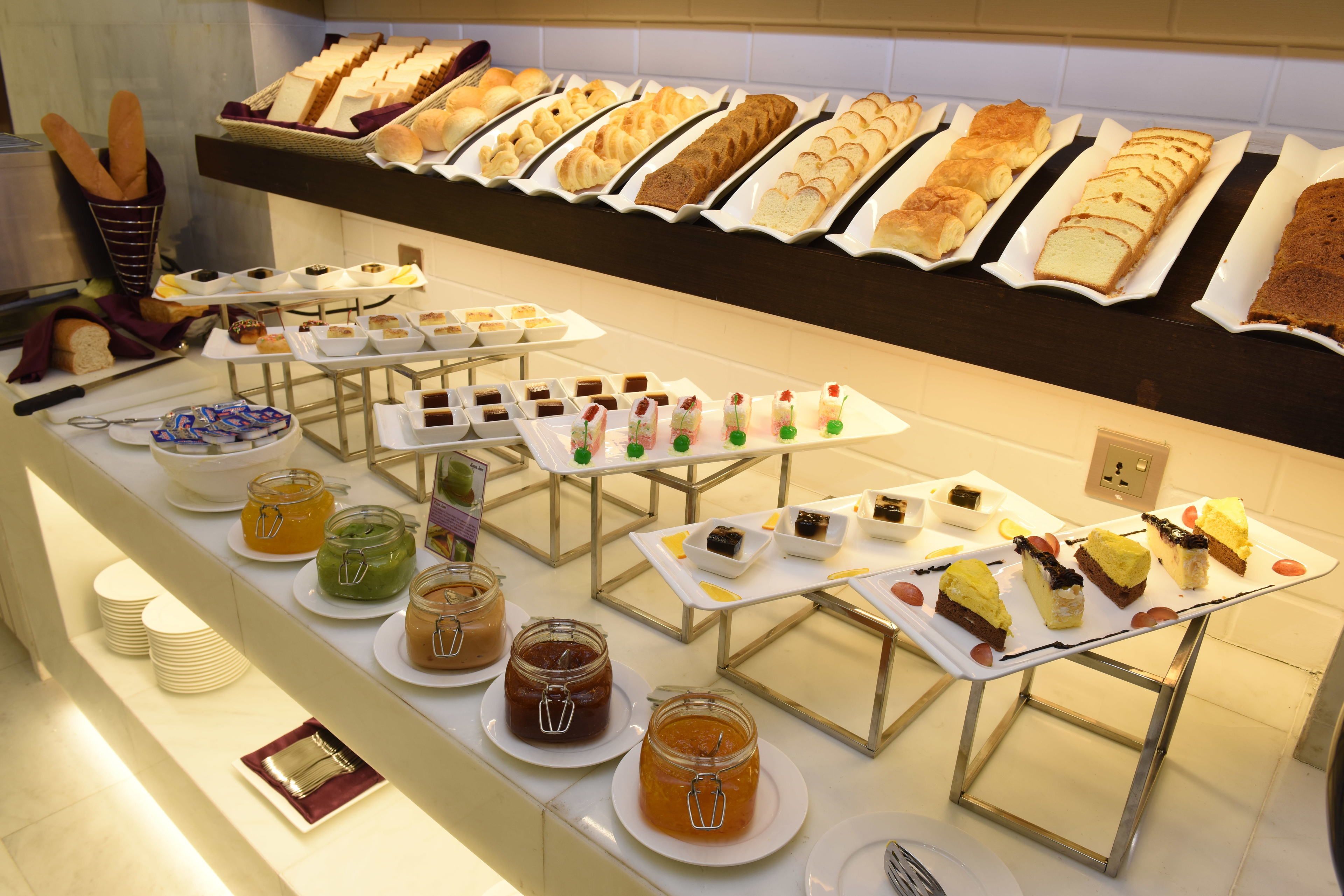 A buffet with various food items and condiments.