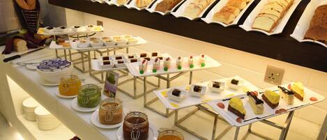 A buffet with various food items and condiments.