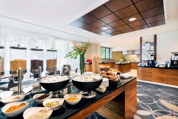 A buffet setup with various food items and a coffee station. - DoubleTree by Hilton Krakow Hotel & Convention Center (Kraków)