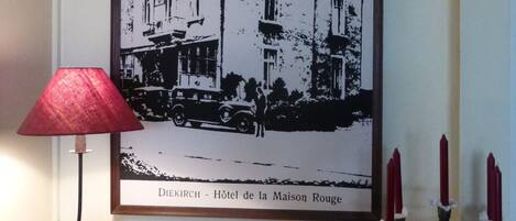 A framed black and white photo of a building labeled "Diekirch - Hôtel de la Maison Rouge".