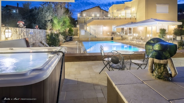 A pool area with hot tubs, outdoor seating, and a staircase leading to a second floor. - Villar (Rosh Pinna)