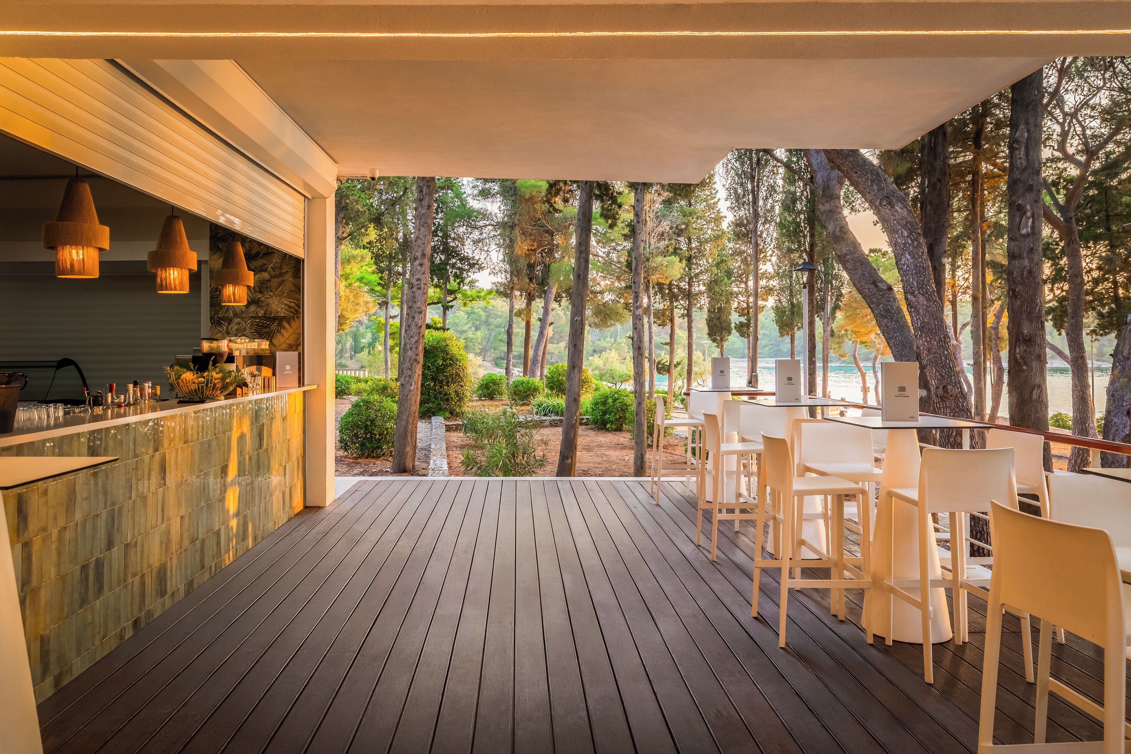 A wooden deck with a bar area and outdoor seating.