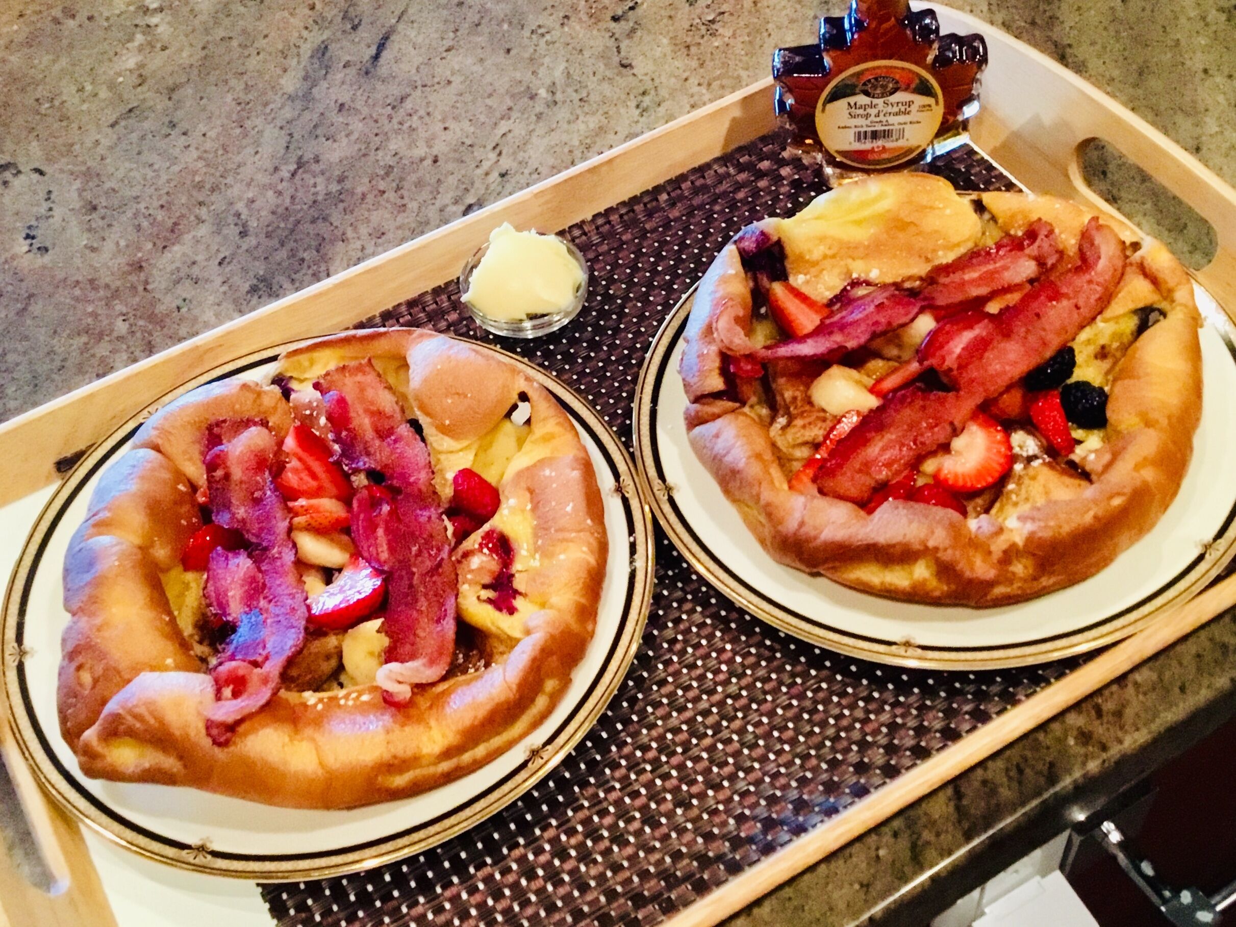 Two pizzas with various toppings on a tray.