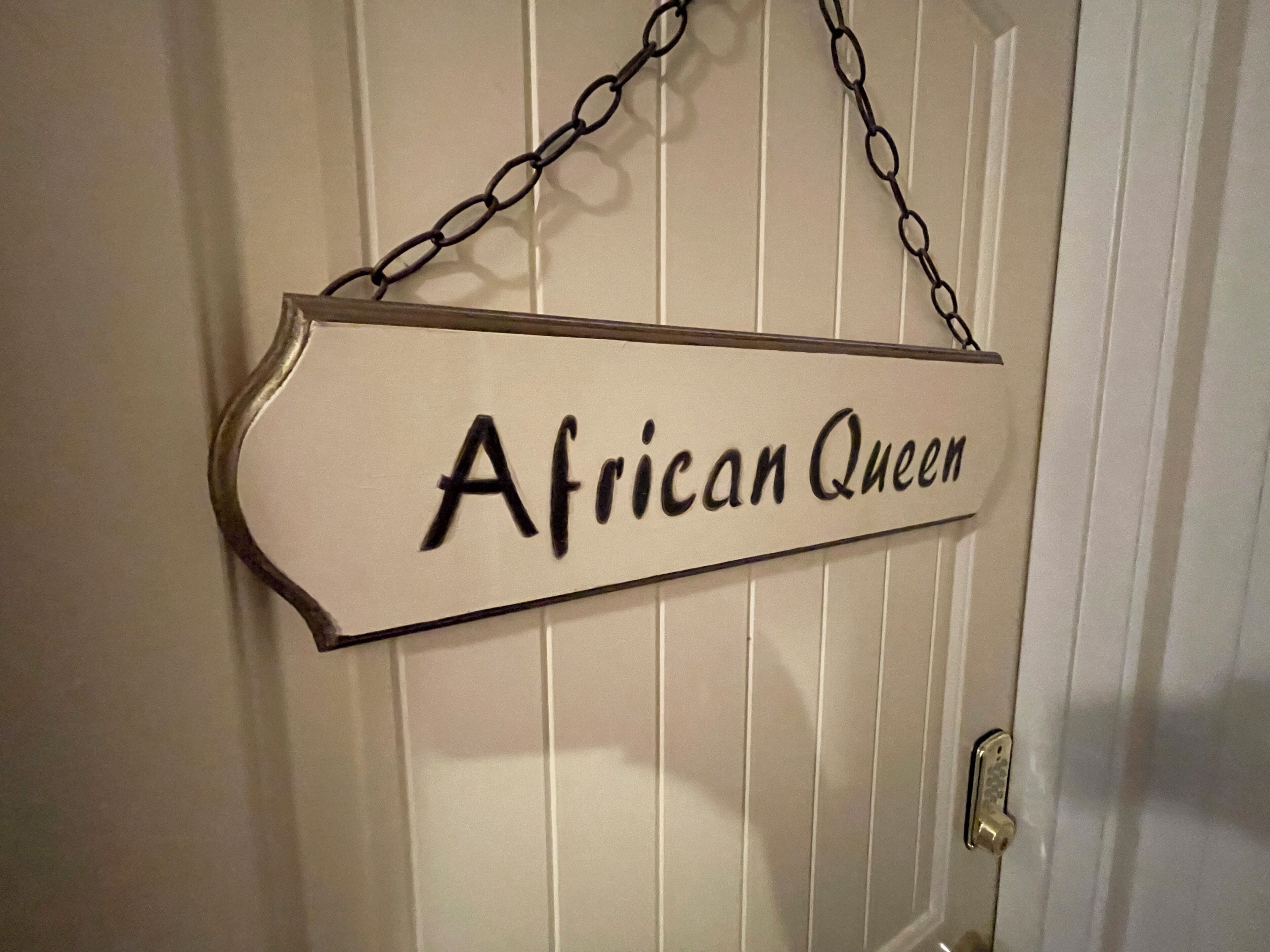 A door with a sign that reads 'African Queen.'