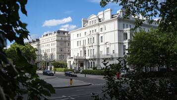 A historic building with classical architecture, featuring multiple stories and a symmetrical facade.
