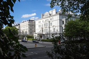 A historic building with classical architecture, featuring multiple stories and a symmetrical facade.