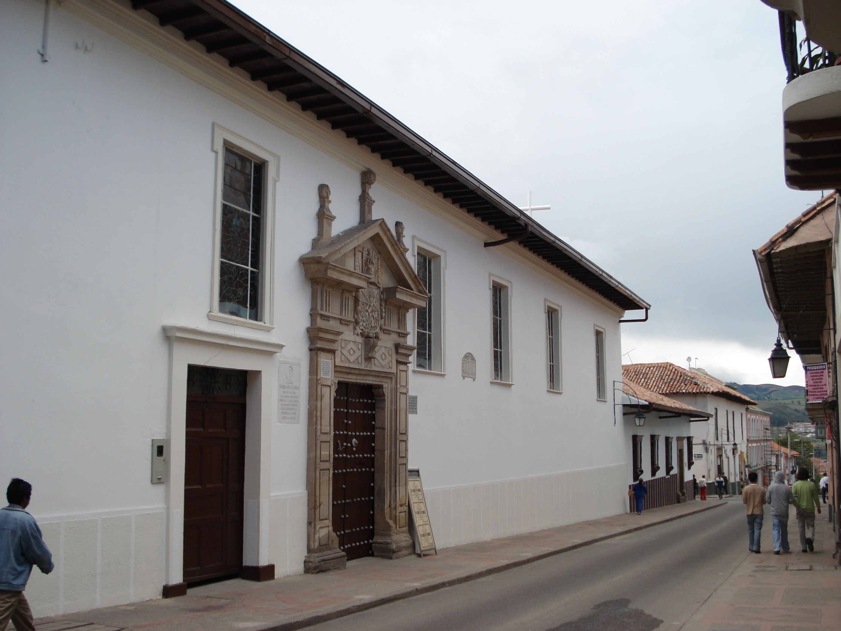 A white building with a large wooden door and a decorative entrance.