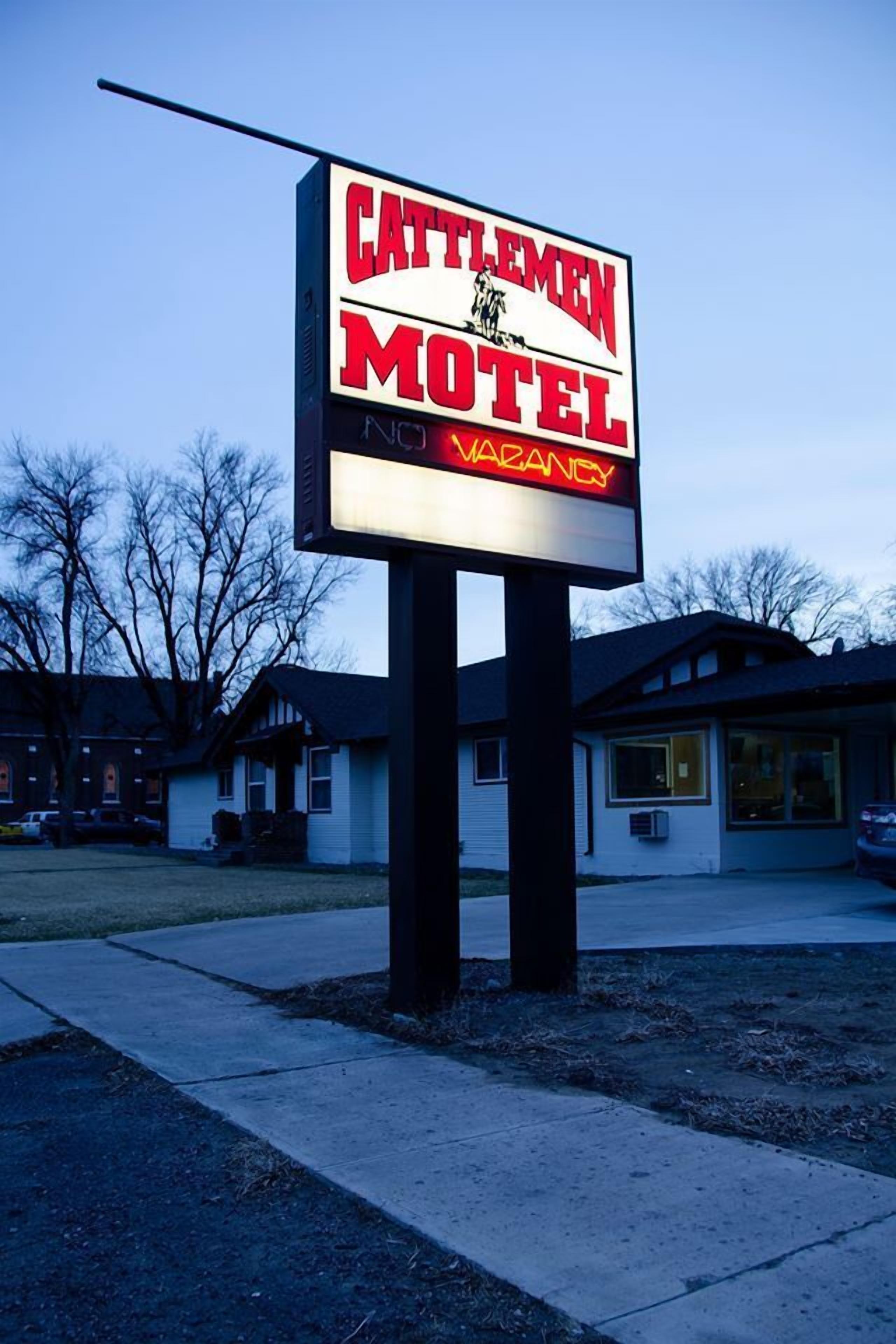 A motel sign with "Cattlemen Motel" and "No Vacancy" displayed.