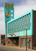 A building with a sign reading 'HYART' and a marquee with a clock.