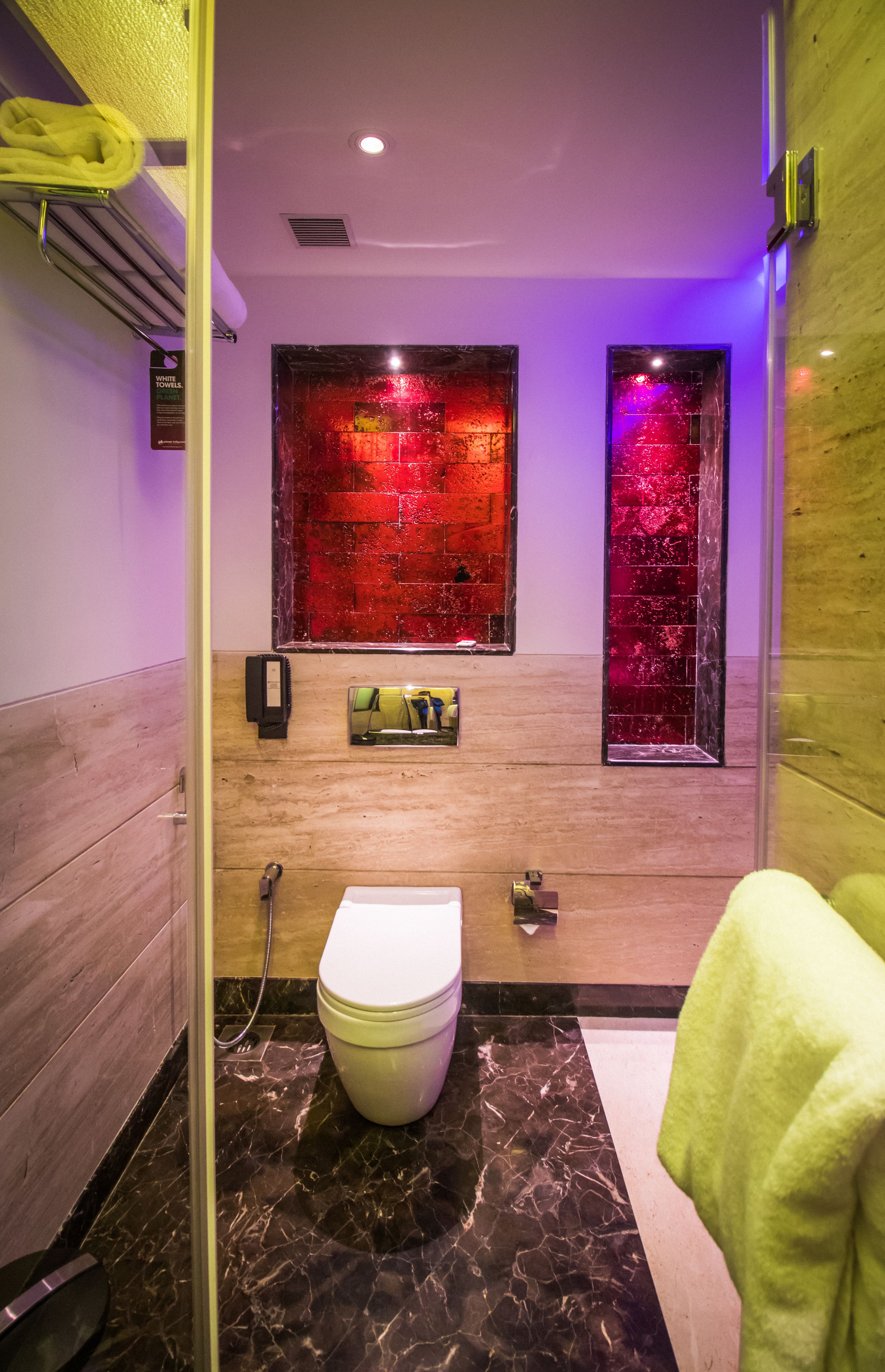 A bathroom with a toilet, a shower, and a sink.