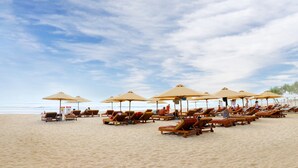 A beach with rows of sun loungers and umbrellas. - Cam Ranh Riviera Beach Resort & Spa (Cam Lam)