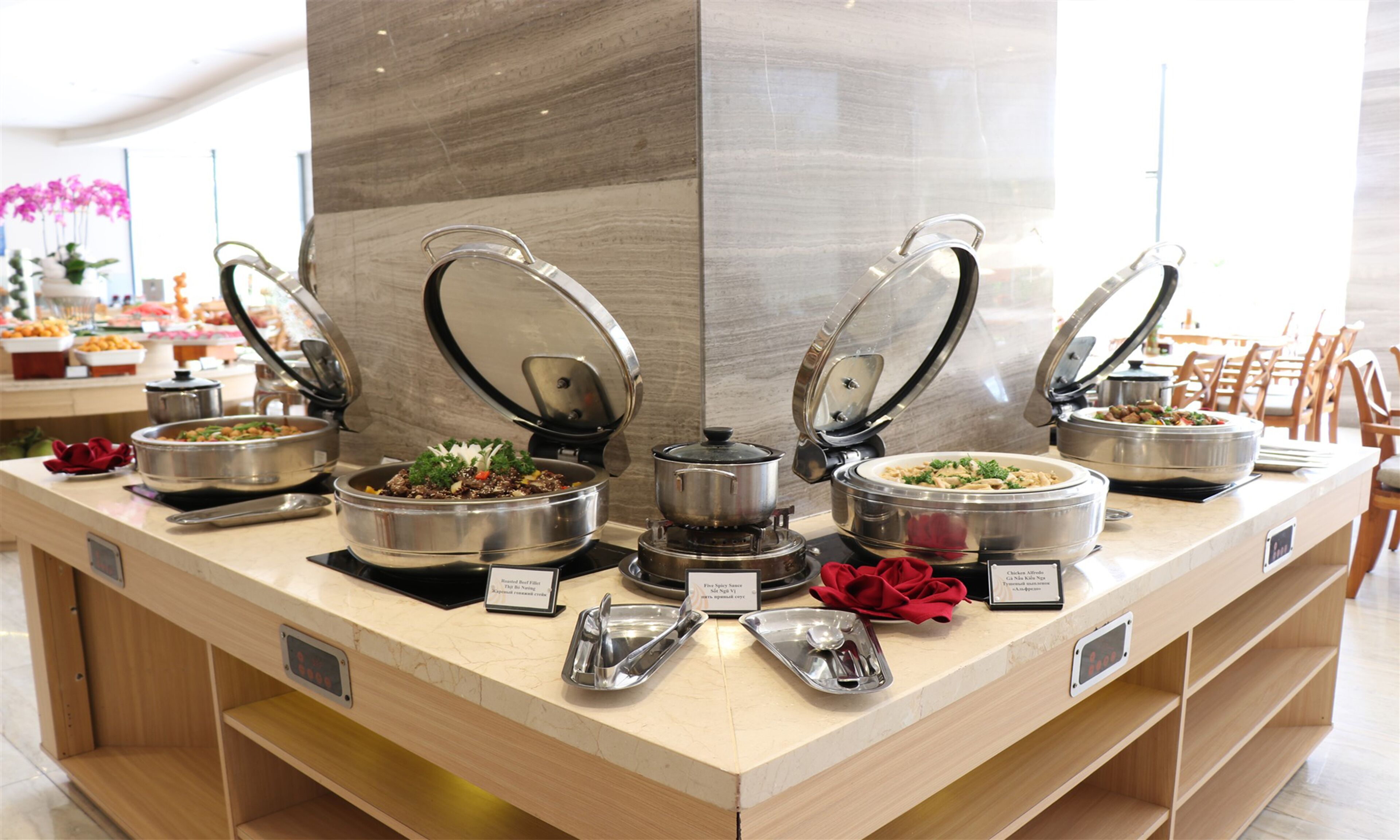 A buffet setup with multiple self-service stations, including a variety of dishes and utensils.