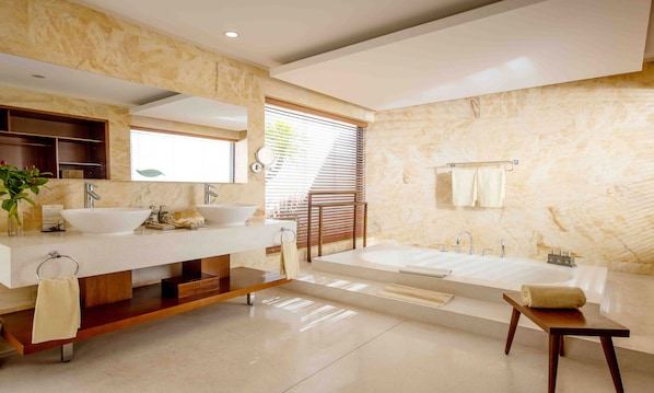 A modern bathroom with two sinks, a large bathtub, and a wooden vanity. - Riviera Beach Resort & Spa (Cam Lam)
