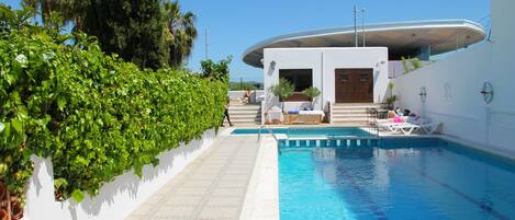 Outdoor pool, open 9:00 AM to 9:00 PM, pool umbrellas, pool loungers