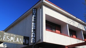 A hotel with a sign reading "HOTEL ESPLANAD".