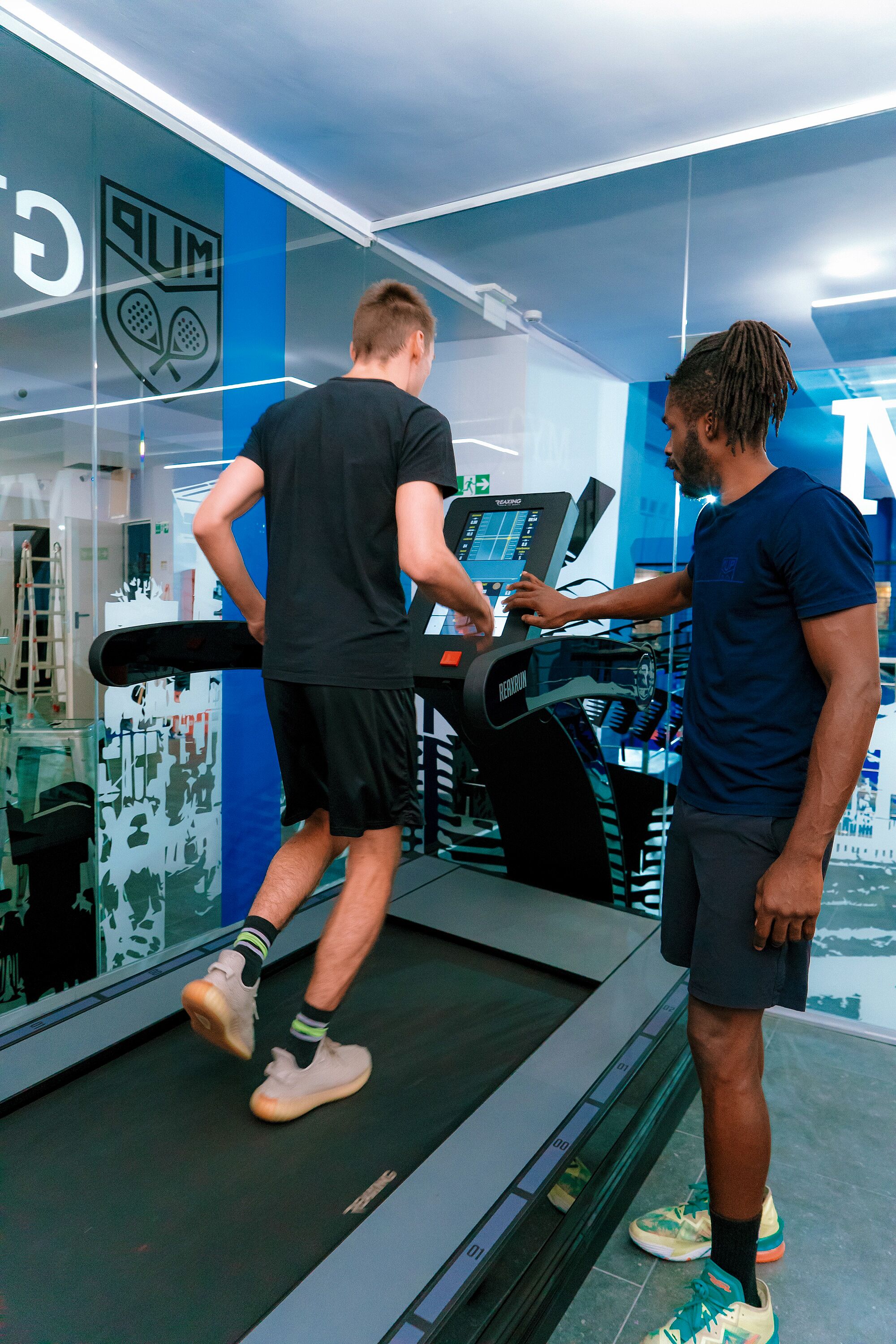 Une salle de sport équipée de tapis de course et d'appareils d'exercice.