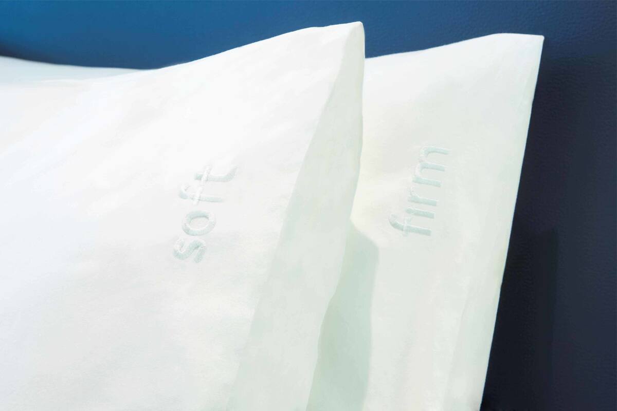 A white paper bag with the words "soft" and "firm" embossed on it.