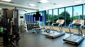 A gym with treadmills, weight machines, and dumbbells. - Holiday Inn Express Jakarta International Expo by IHG (Jakarta)