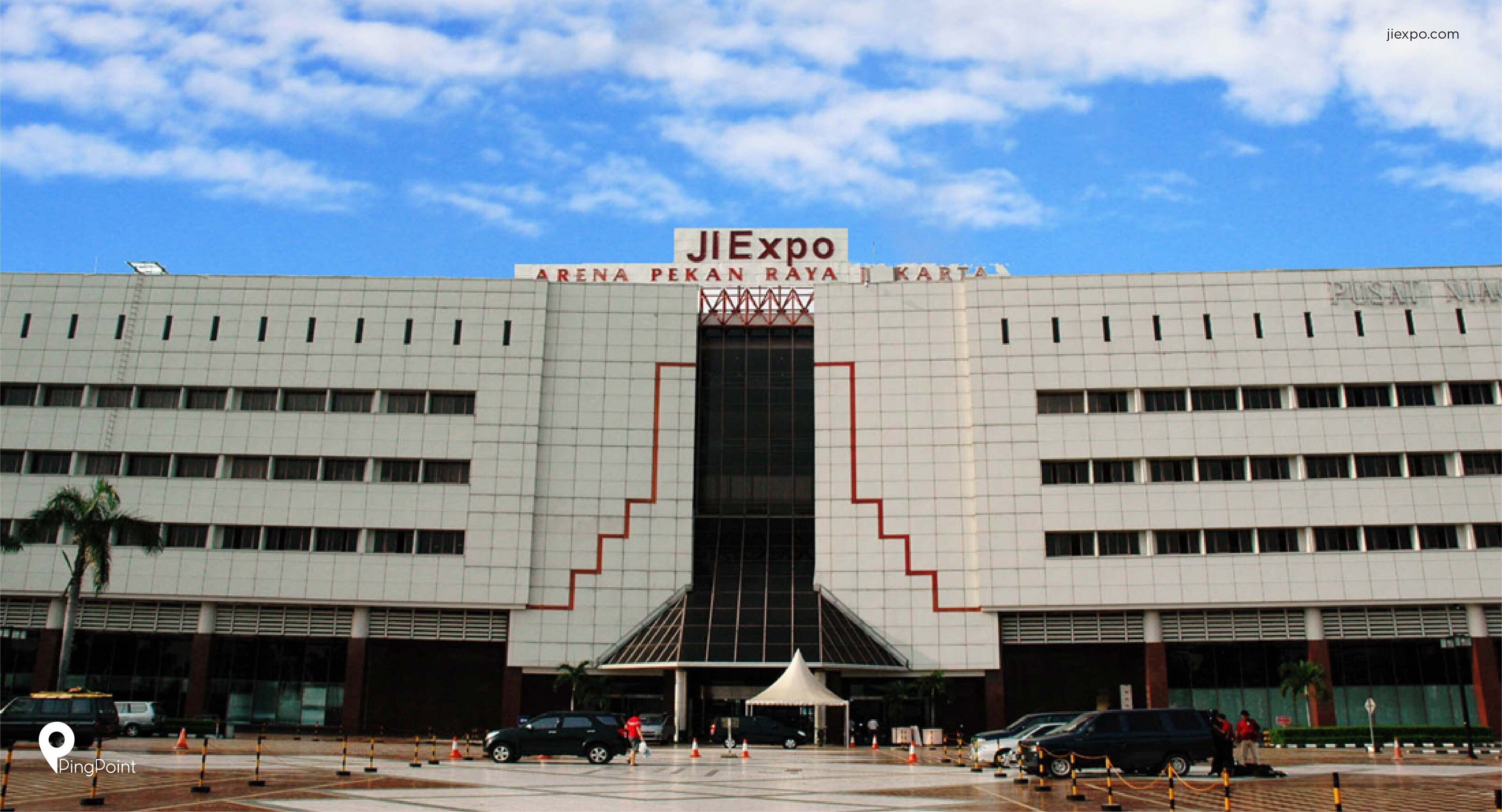 A large, modern building with a prominent entrance and a large sign above the doors.