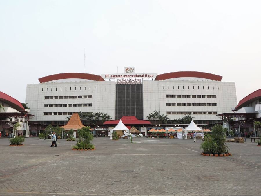 A large, modern building with a sign reading "PT Jakarta International Expo."