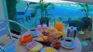 Enjoy a leisurely breakfast with a view of the pool and surrounding landscape from this outdoor dining area.