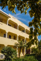 A multi-story building with balconies and a courtyard.