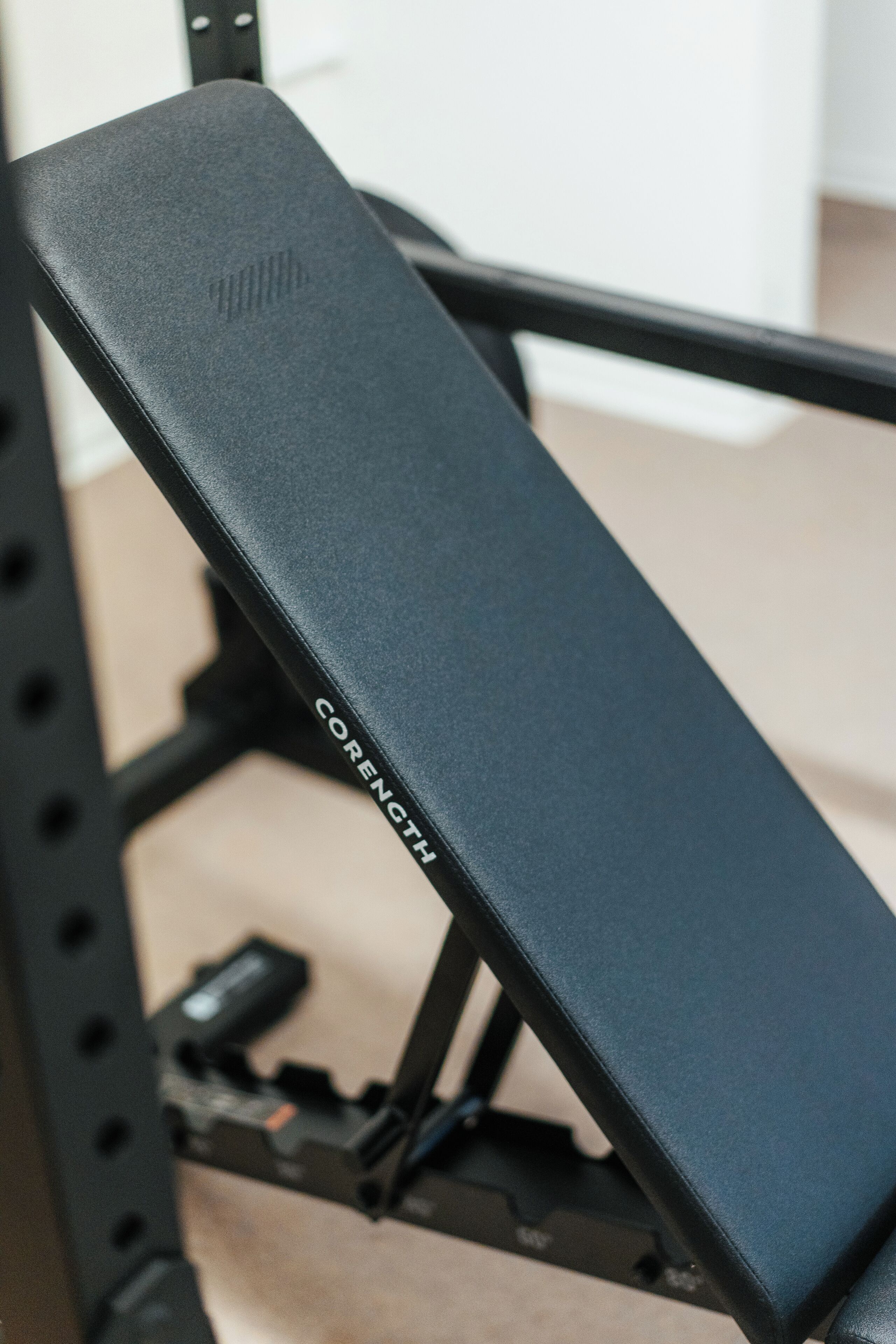 A black bench with the word "CORENTH" on it, part of a metal frame structure.