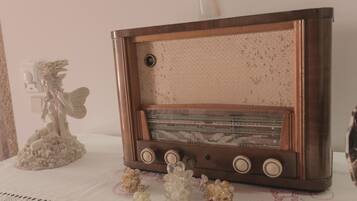 A vintage radio on a table with decorative items.