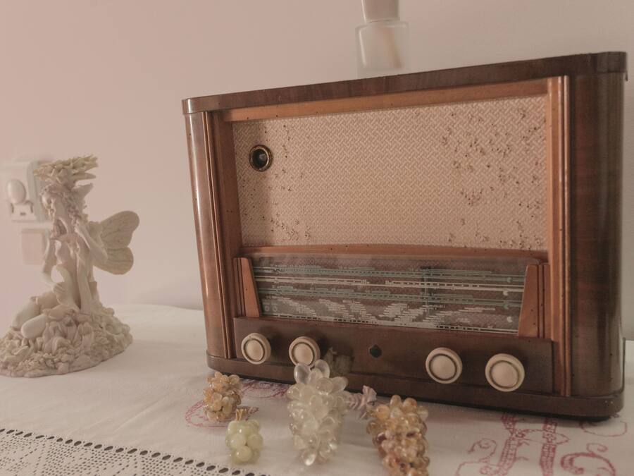 A vintage radio on a table with decorative items.