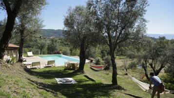 Seasonal outdoor pool, open 9:00 AM to 8:00 PM, pool umbrellas