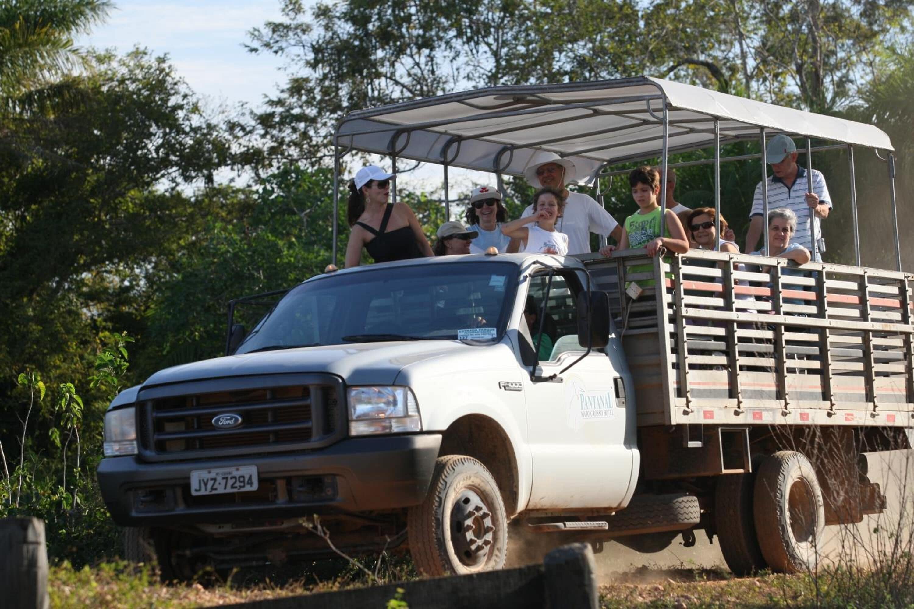 A white Ford truck with a covered cargo area and a visible license plate.