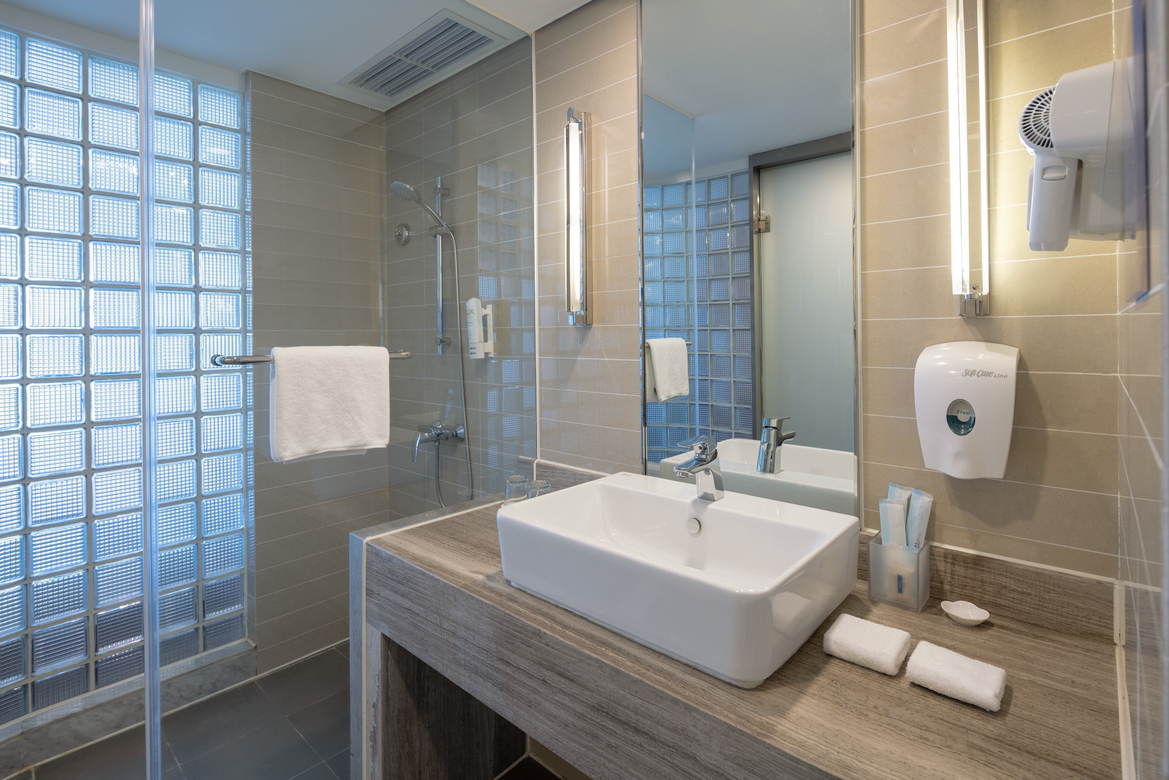 shower, hair dryer, slippers, towels