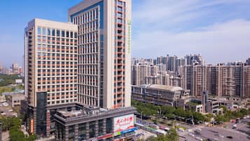 A high-rise building with multiple floors, surrounded by a cityscape.