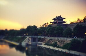 A traditional building with a distinct architectural style, situated beside a calm river. - Holiday Inn Express Xi'an High-tech Zone by IHG (Xi'an)