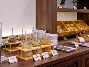 A breakfast buffet with various food items and serving utensils. - ibis Styles Trier (Trier)
