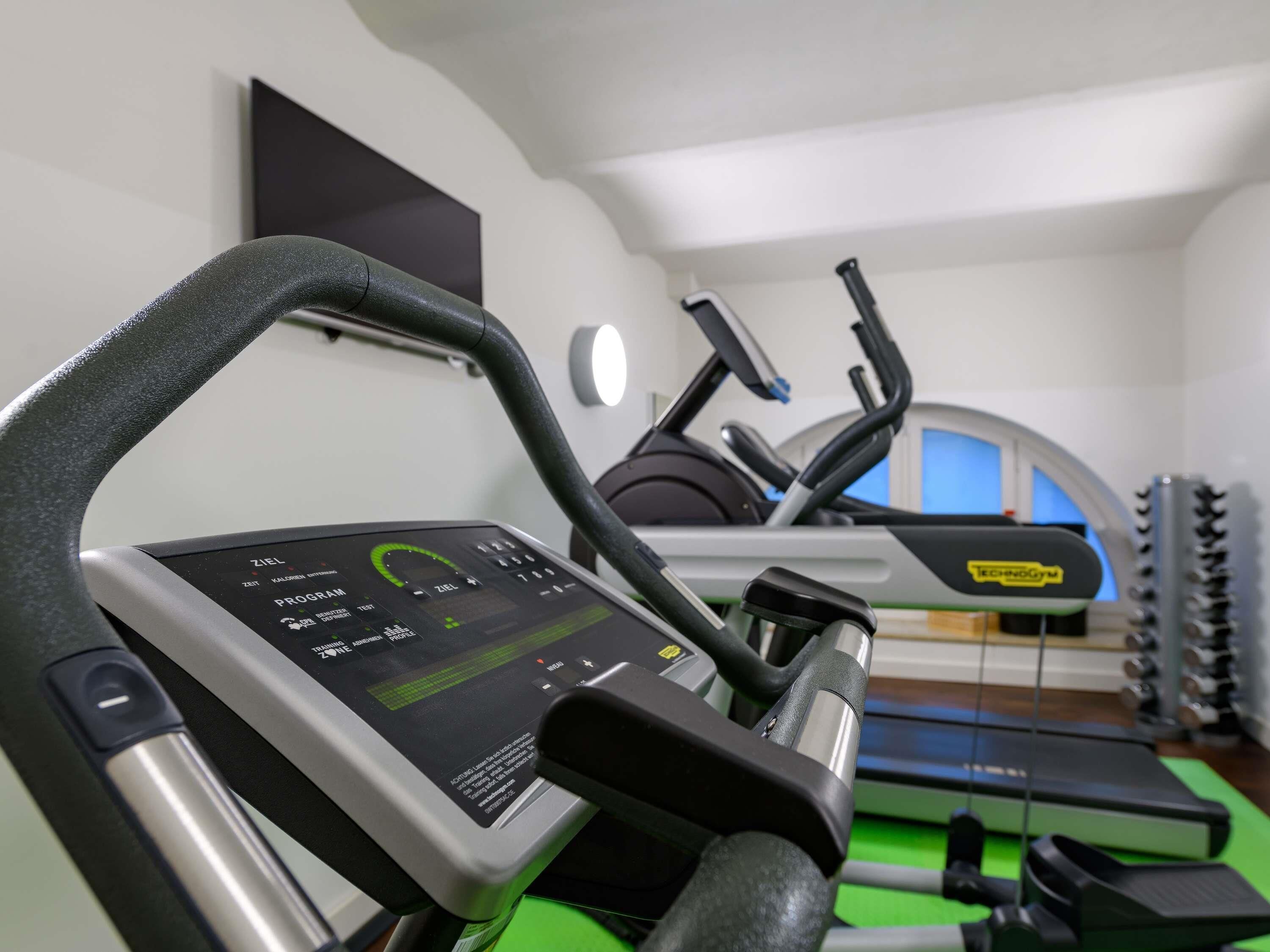 A gym with treadmills and exercise equipment.