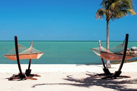 On the beach, beach cabanas, sun loungers