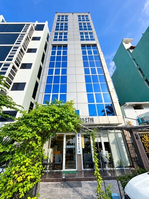 A modern building with a prominent entrance, large windows, and a sign that reads 'RIVETHI'.