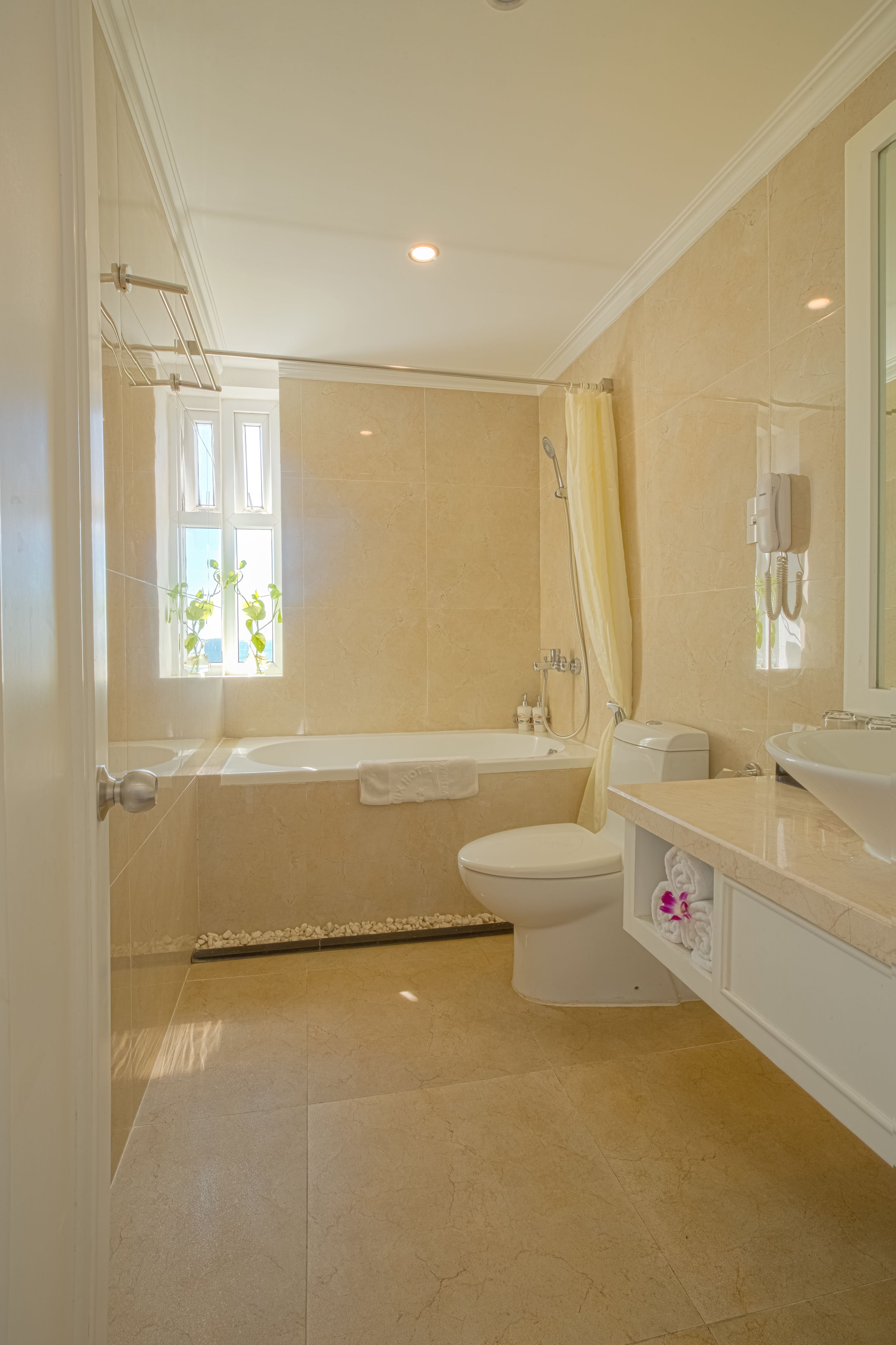 A bathroom with a bathtub, toilet, and sink.