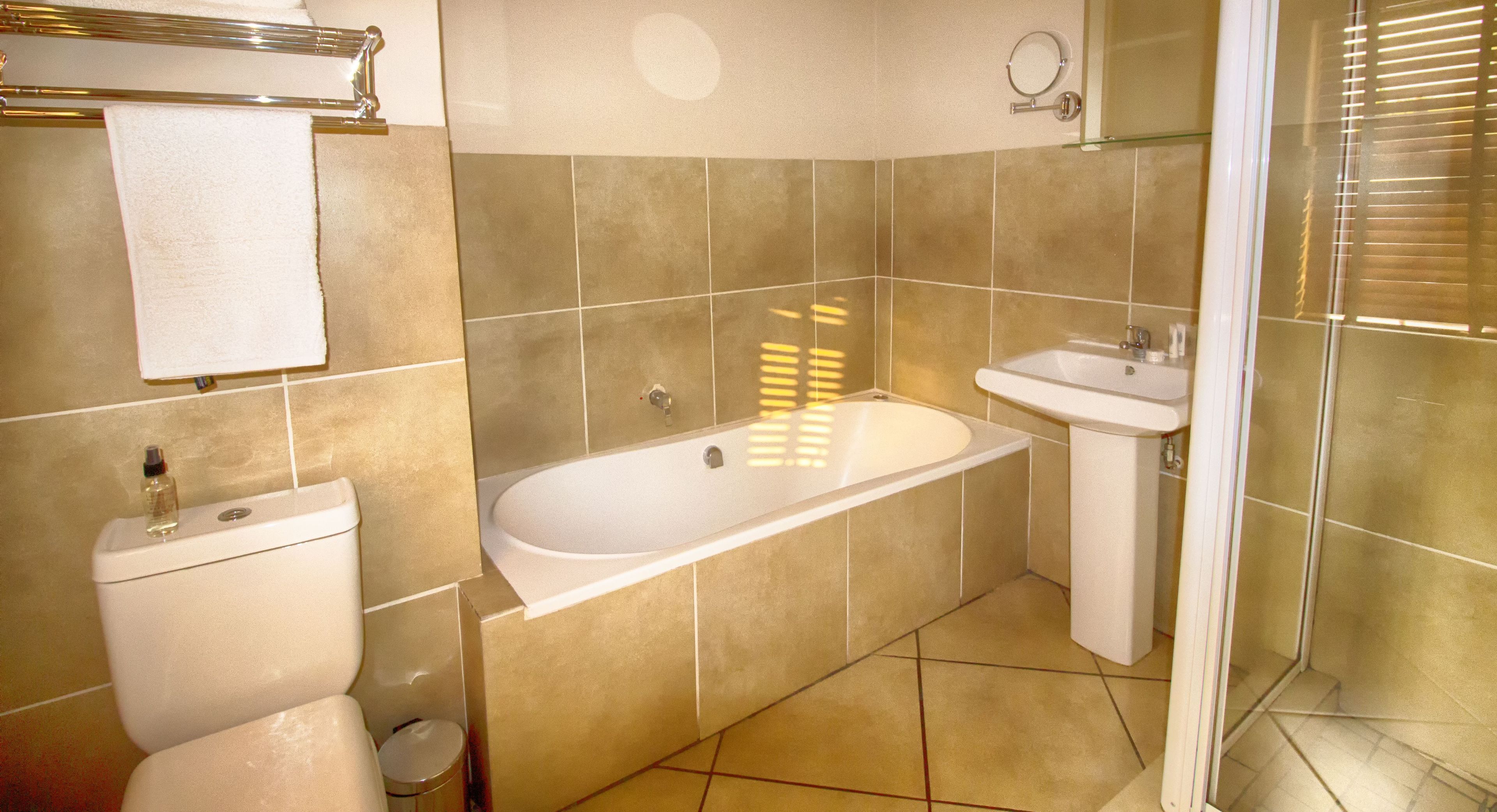 family room | bathroom | shower, rainfall showerhead, designer toiletries, hair dryer