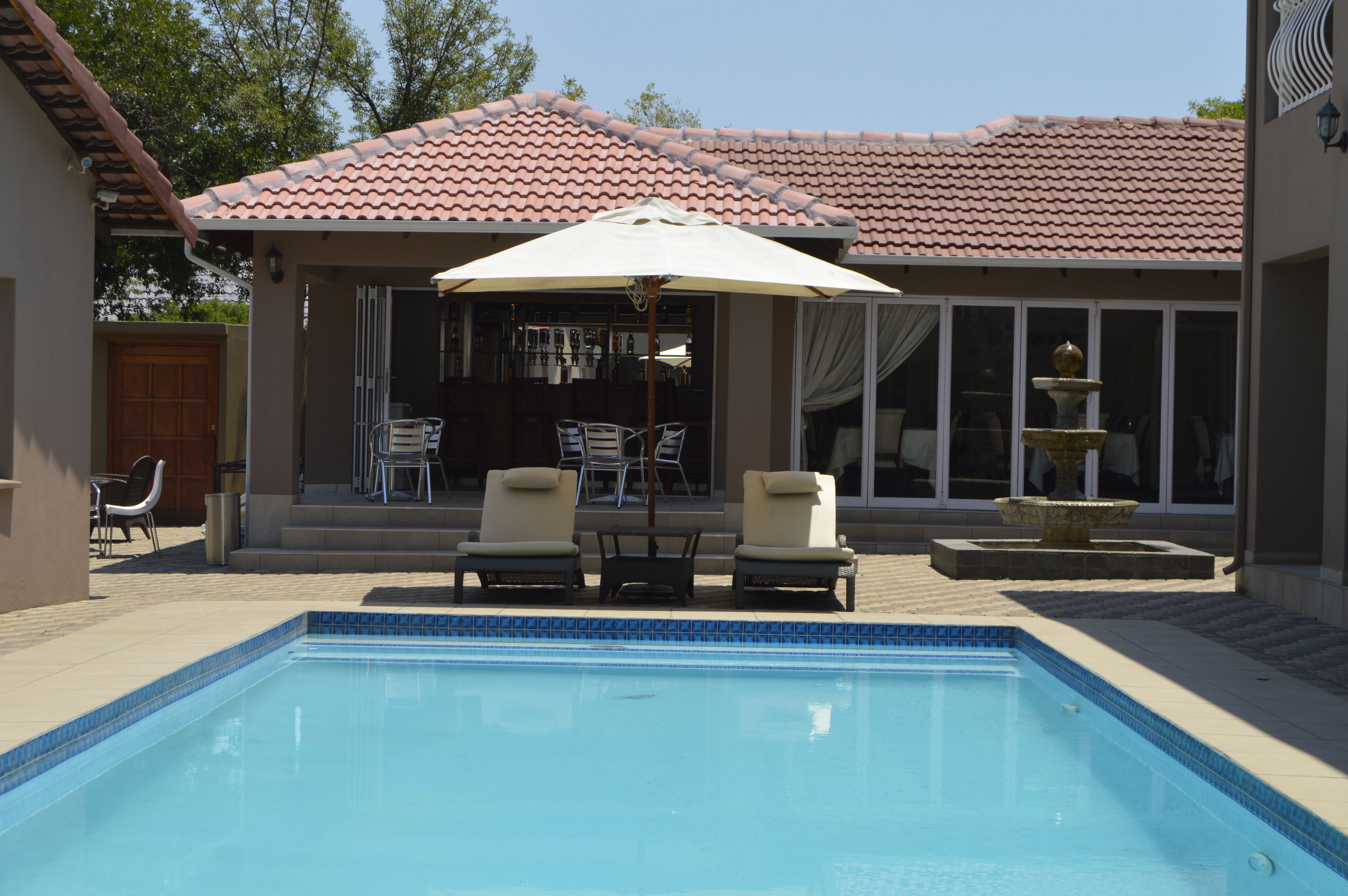 outdoor pool, pool umbrellas, pool loungers