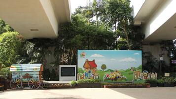Children can play and explore in this outdoor area featuring a colorful mural and play structure.