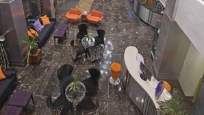 A spacious lobby with a reception desk, seating areas, and a chandelier. - Hive Hotel and Convention Place (Quezon City)