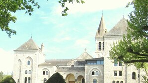 A historic stone building with multiple towers, a central courtyard, and well-manicured hedges. - Hotel de la Montagne Noire (Dourgne)