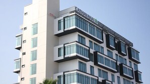 A multi-story hotel building with a modern architectural design, featuring a prominent "CATHAYANA" sign on the top. - Cathayana Hotel (Kuantan)