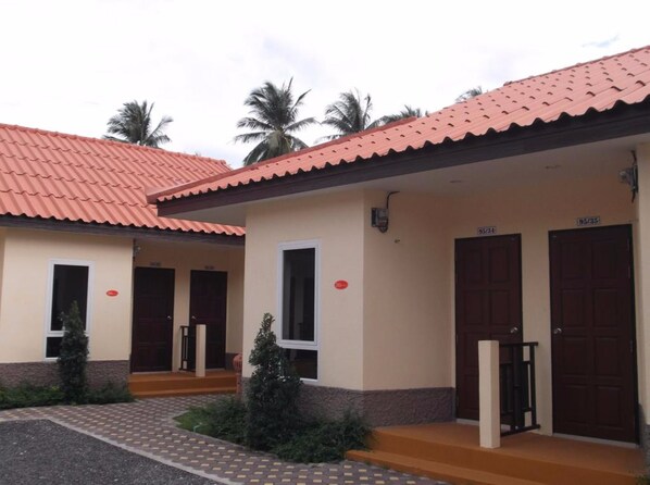 A building with a red-tiled roof, two doors, and a small porch area. - At Lamai Resort (Koh Samui)