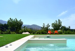 Seasonal outdoor pool, open 9:00 AM to 8:00 PM, pool umbrellas